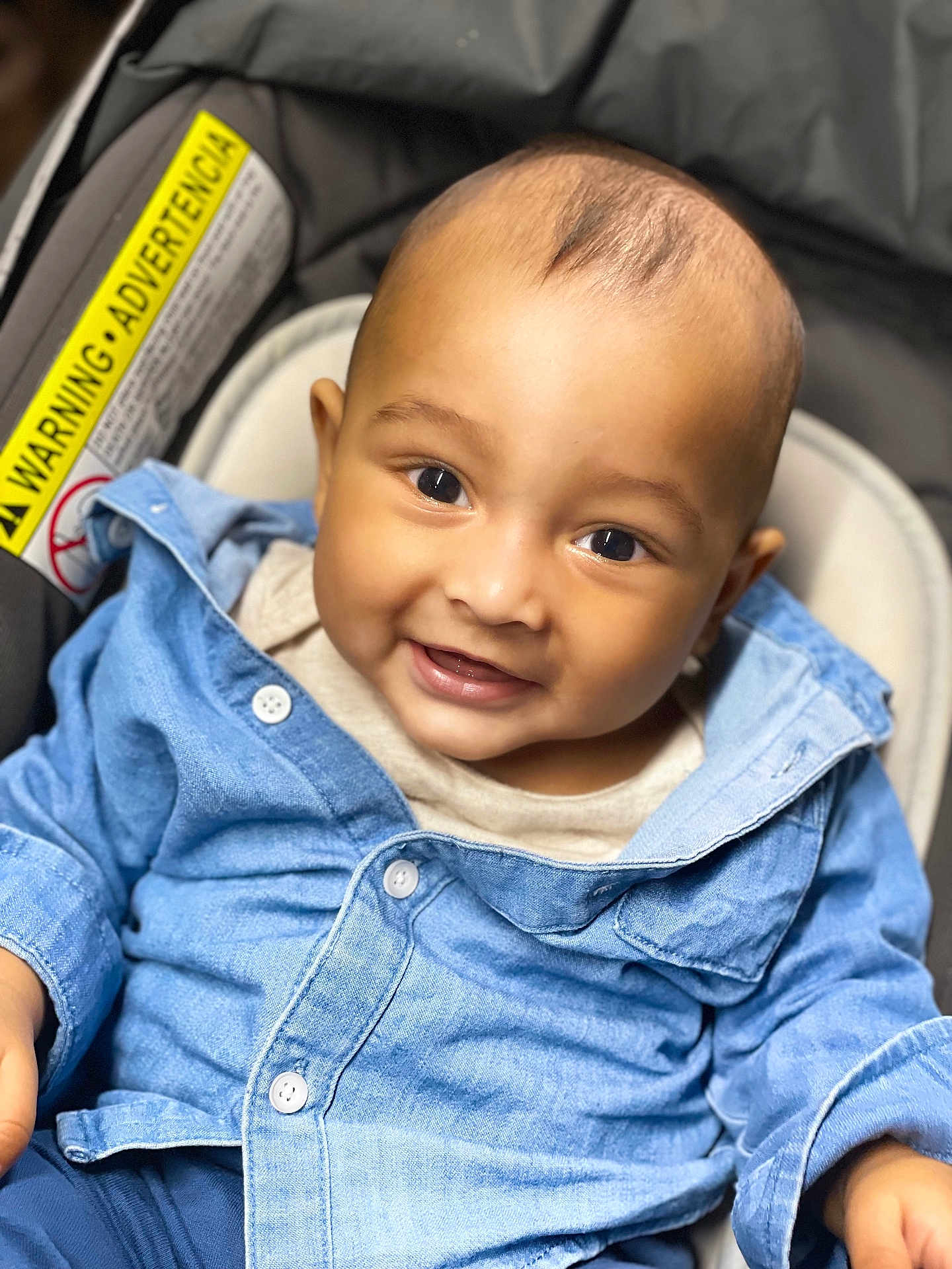 Ahaan is registered to the contest to win money with this photo: baby, child, smile, denim_shirt, car_seat, happy, portrait, infant, cute, clothing, buttoned_shirt, closeup, face, person, young_child, baby_boy, casual_wear, indoor, joyful, seated