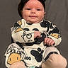 Pearllynn is registered to the contest to win money with this photo: baby, headband, bow, smile, infant, clothing, onesie, pattern, cow_print, socks, lying_down, cute, child, adorable, face, happy, indoors, soft, person, portrait