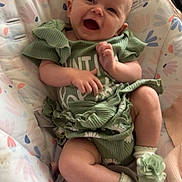 Pearllynn is registered to the contest to win money with this photo: baby, infant, smiling, green_outfit, baby_shoes, flower_decor, baby_seat, patterned_fabric, happy, cute, child, portrait, indoor, soft_lighting, baby_clothing, sitting, small_hands, cheerful, cozy, infant_smile