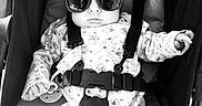 Sofia joined the competition — help win amazing prizes! baby, sunglasses, stroller, infant, child, black_and_white, baby_clothing, straps, pacifier, legs, sitting, outdoor, sunlight, shade, cute, face, portrait, relaxed, fashion, accessory