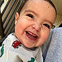 Ezekiel is registered to the contest to win money with this photo: baby, smiling, face, teeth, sweater, clothing, child, infant, person, portrait, happy, closeup, cute, eyes, eyelashes, handheld, outdoor, railing, fabric, head