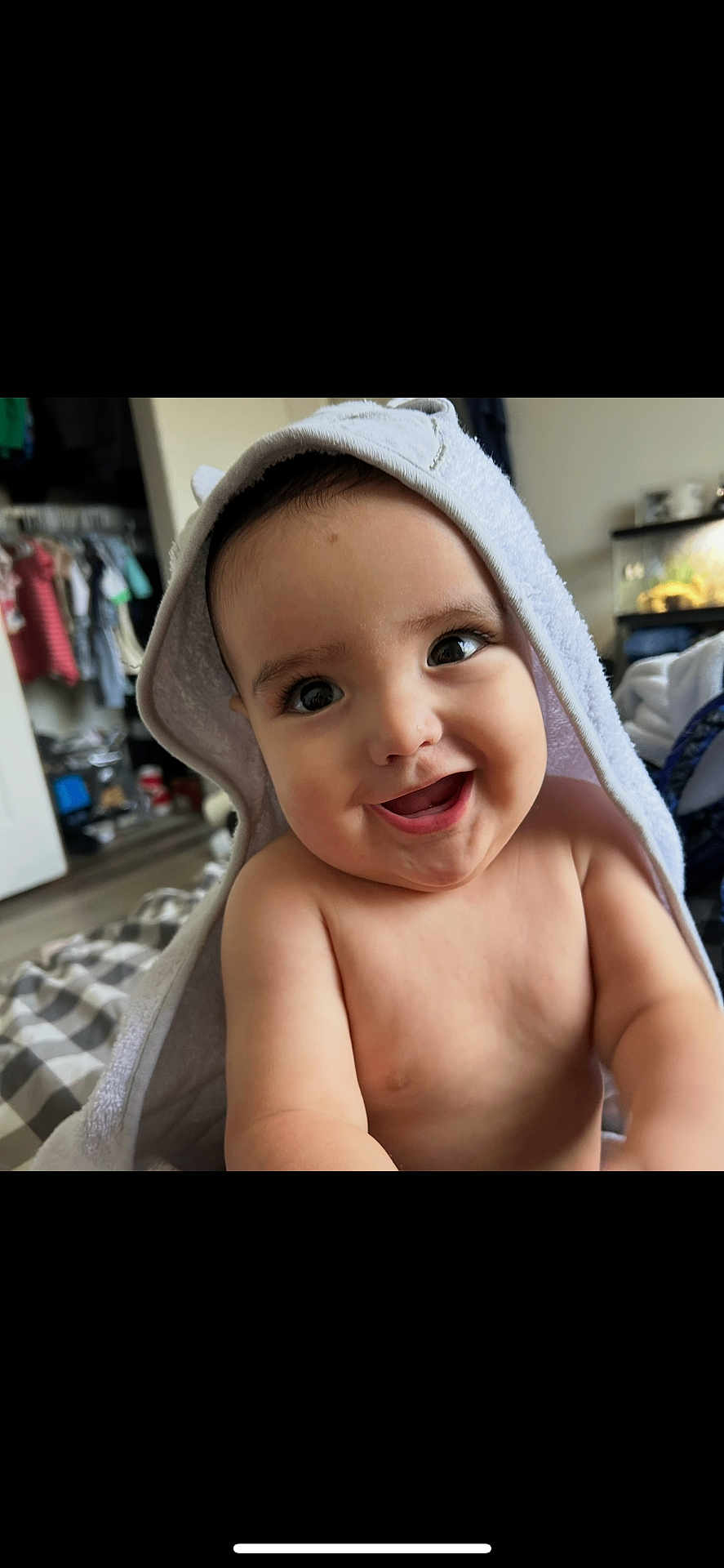 Ezekiel is registered to the contest to win money with this photo: baby, child, smiling, towel, hooded_towel, indoor, portrait, happy, cute, skin, face, eyes, infant, person, baby_towel, closeup, expression, room, soft, clothing