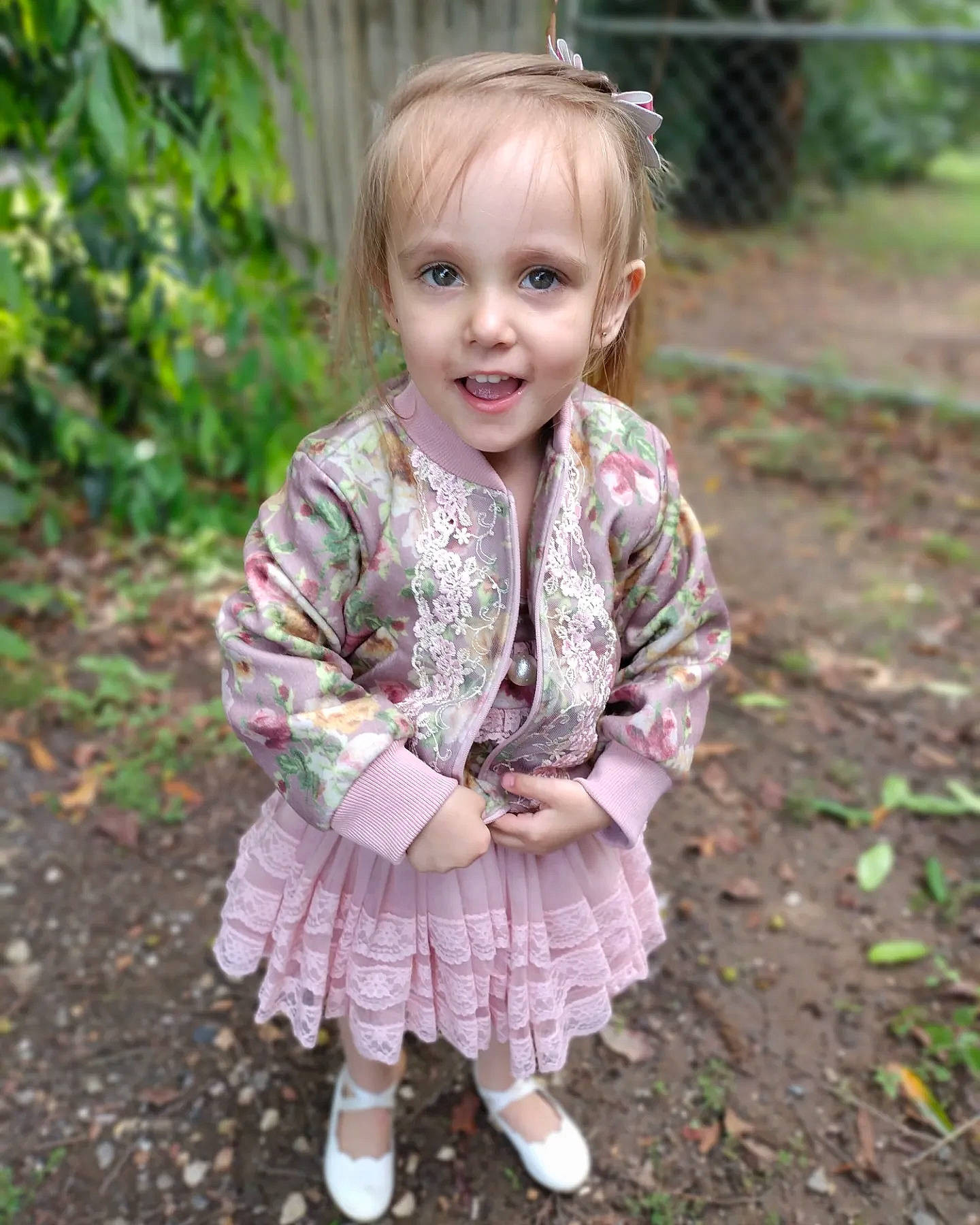 Willow is registered to the contest to win money with this photo: baby_toddler_clothing, blond, child, eye, face, grass, hair, hairstyle, happy, head, magenta, outerwear, pattern, people_in_nature, person, pink, plant, sleeve, smile, spring
