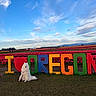 Simba is registered to the contest to win money with this photo: dog, white_dog, samoyed, sign, colorful_letters, i_love_oregon, tulip_field, flowers, red_flowers, green_grass, blue_sky, clouds, outdoor, nature, landscape, spring, pet, animal, park, scenic_view
