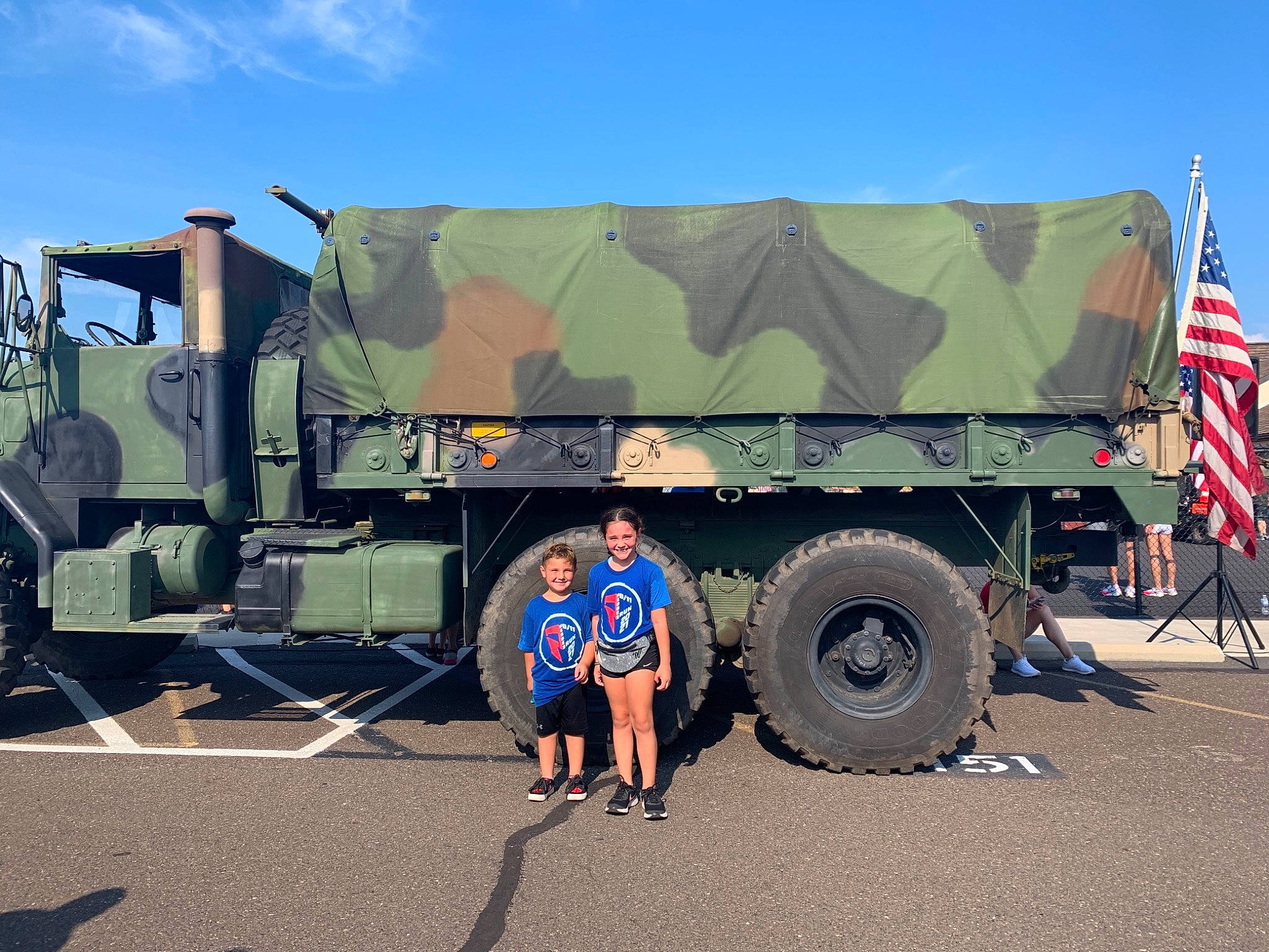 Kira joined the competition — help win amazing prizes! asphalt, automotive_exterior, automotive_tire, automotive_wheel_system, bumper, commercial_vehicle, flag, flag_of_the_united_states, joy, landscape, mode_of_transport, motor_vehicle, person, road_surface, rolling, shorts, sky, tire, travel, truck