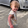 Adelina joined the competition — help win amazing prizes! toddler, child, barefoot, outdoor, side_view, smiling, casual_clothing, concrete, car, silver_car, sunlight, hair, pigtails, playful, happy, young_child, daylight, vehicle, small_person, curly_hair