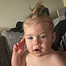 baby, blue_eyes, casual, child, couch, expression, face, food, gesture, hair, home, indoor, messy, person, ponytail, seated, skin, sofa, toddler, young_child