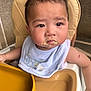 Renzo is registered to the contest to win money with this photo: baby, child, high_chair, bib, food, messy_face, feeding, indoor, infant, cute, face, expression, person, seat, skin, hair, scrape, arm, clothing, table