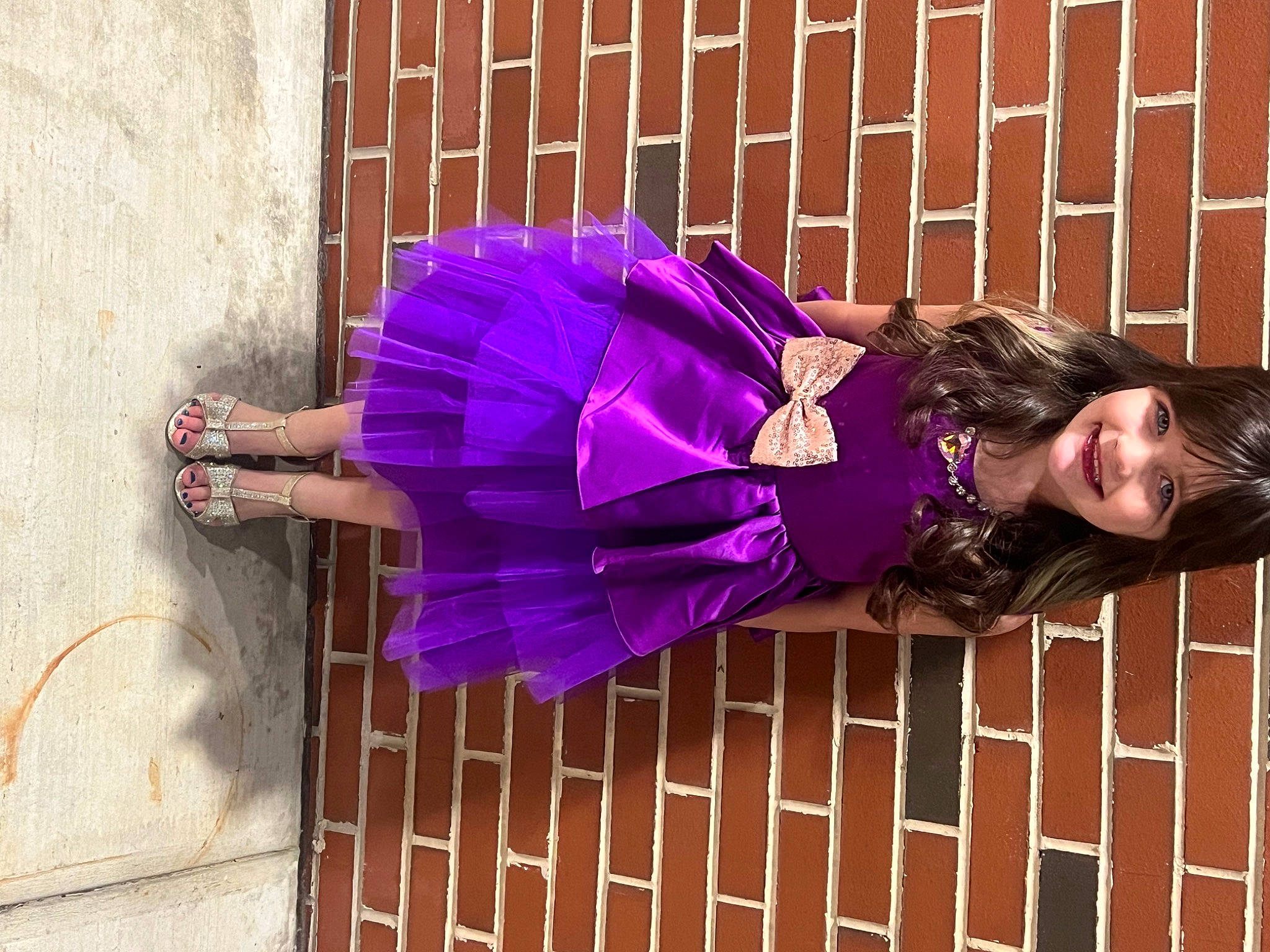 Harper is registered to the contest to win money with this photo: brick, cocktail_dress, costume, dress, electric_blue, fashion_design, fur, happy, human_leg, joy, leg, magenta, pattern, person, pink, purple, red, sitting, smile, thigh