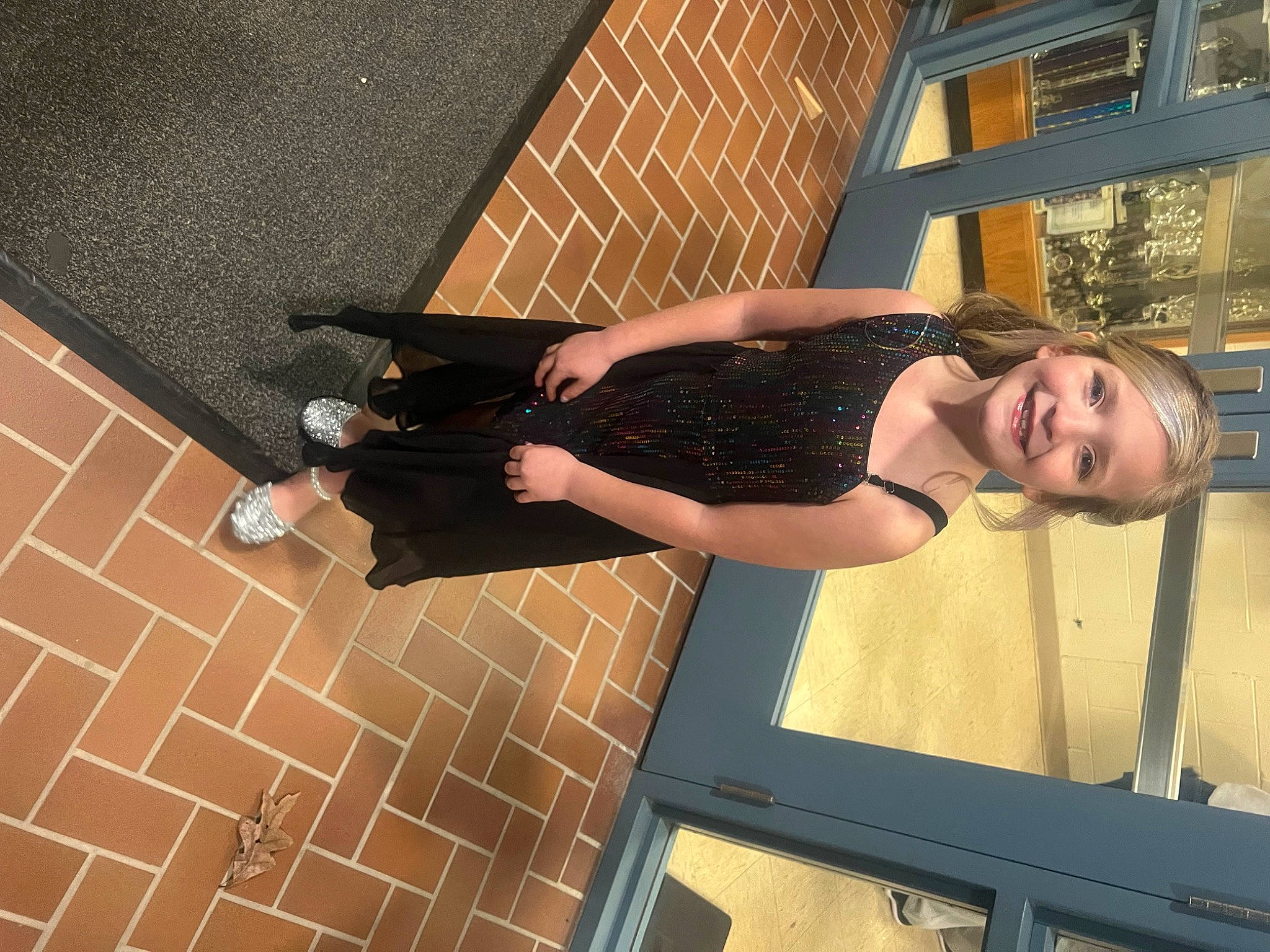 Briella is registered to the contest to win money with this photo: arm, brickwork, cocktail_dress, composite_material, elbow, fashion, flash_photography, flooring, fun, human_leg, joint, joy, knee, pattern, person, smile, standing, thigh, waist, window