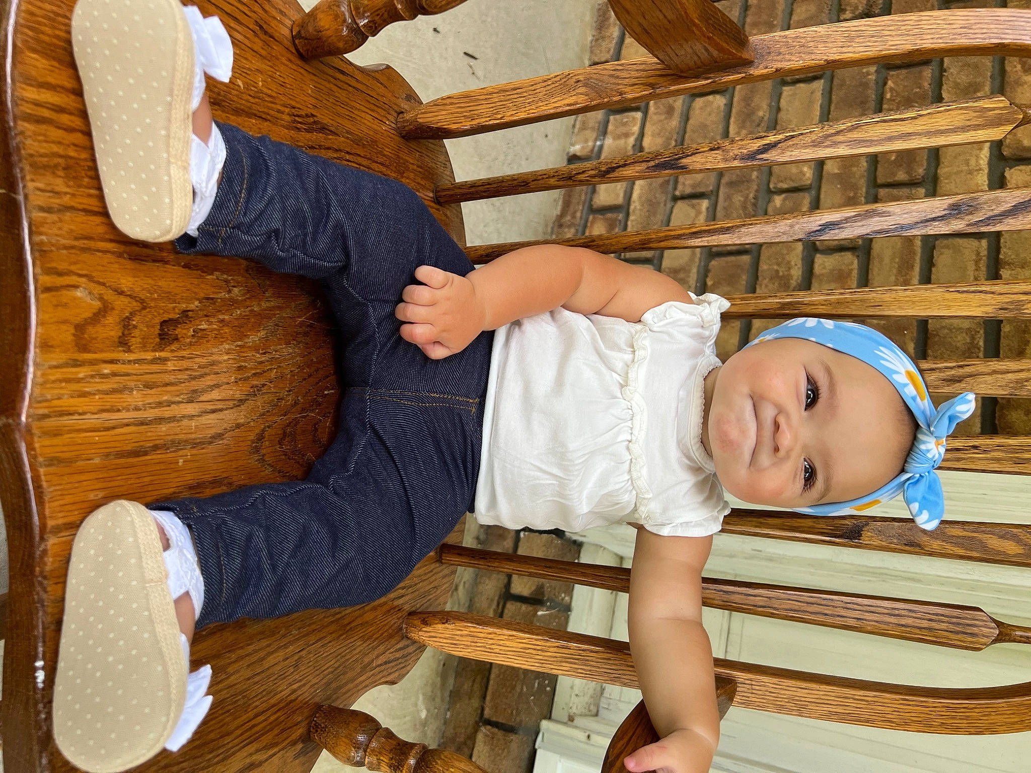 Elena is registered to the contest to win money with this photo: baby, baby_toddler_clothing, chair, child, comfort, elbow, flooring, fun, happy, hardwood, headgear, headwear, human_body, leisure, outdoor_furniture, person, room, sandal, sitting, toddler