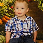 Charles joined the competition — help win amazing prizes! child, toddler, boy, plaid_shirt, jeans, sitting, wooden_crate, vegetable_backdrop, carrots, cabbage, strawberry, portrait, smiling, indoor, studio_photo, casual_clothing, cute, young_child, short_hair, face