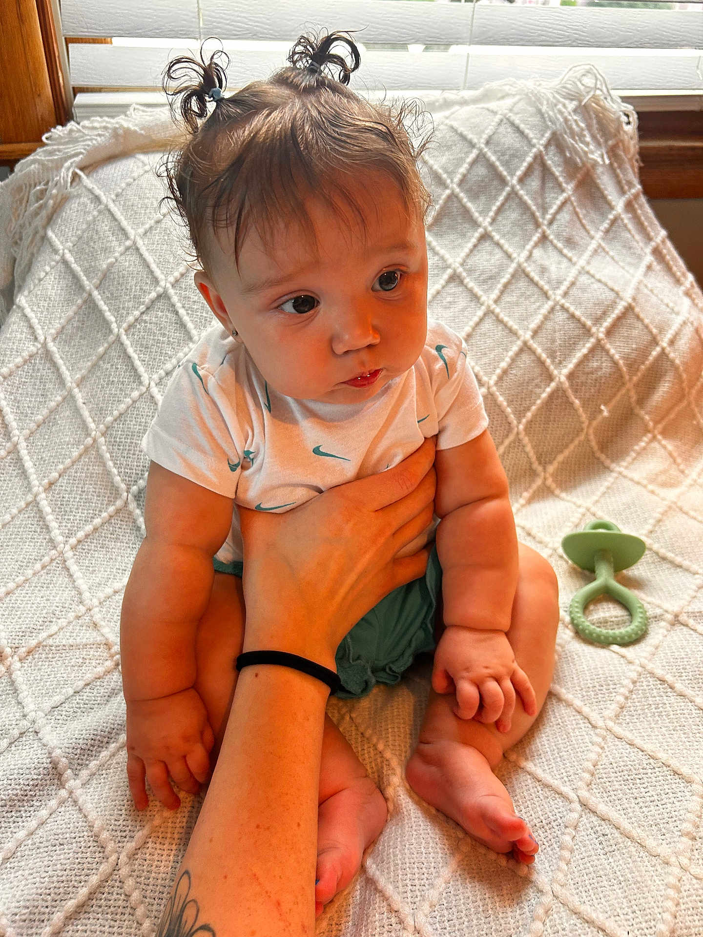 Mazy joined the competition — help win amazing prizes! baby, child, infant, person, hand, tattoo, hair_tie, ponytails, pacifier, blanket, texture, sitting, cute, indoor, skin, clothing, expression, support, foot, arm