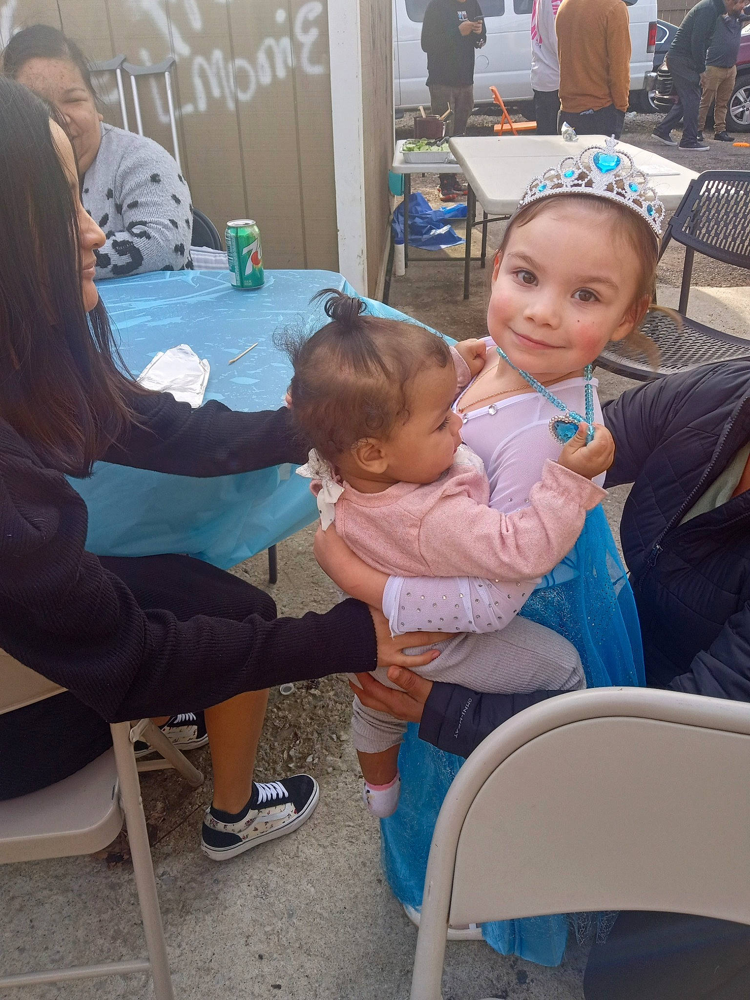 Cheyenne Rain Vandeventer joined the competition — help win amazing prizes! baby, chair, event, fun, furniture, hairstyle, happy, human, interaction, joy, lap, leg, leisure, mammal, person, product, public_space, sandal, sharing, sitting