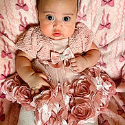 Malia is registered to the contest to win money with this photo: baby, infant, pink_dress, fabric_roses, blanket, bows, white_shoes, tights, cute, wide_eyes, portrait, child, indoors, soft_texture, clothing, adorable, fashion, laying_down, young_child, headband