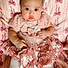 baby, infant, pink_dress, fabric_roses, blanket, bows, white_shoes, tights, cute, wide_eyes, portrait, child, indoors, soft_texture, clothing, adorable, fashion, laying_down, young_child, headband