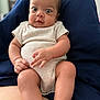 Mariah joined the competition — help win amazing prizes! baby, infant, child, person, clothing, onesie, legs, arms, face, eyes, lap, sitting, skin, indoor, people, cute, expression, comfort, casual, relaxed