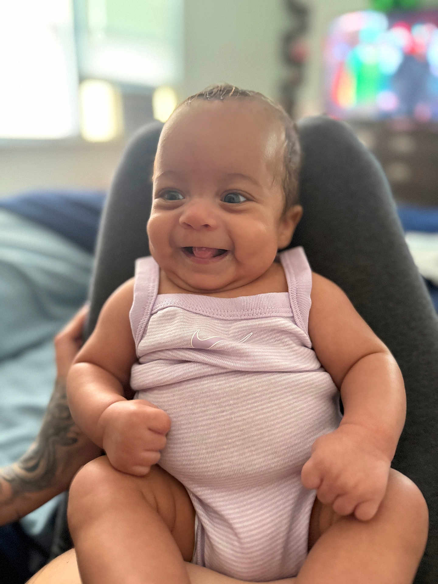 Mariah is registered to the contest to win money with this photo: baby, smiling, infant, onesie, happy, person, legs, skin, indoor, cute, cheerful, portrait, child, clothing, sitting, young, expression, human, comfortable, casual