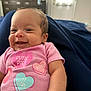 Mariah joined the competition — help win amazing prizes! baby, smiling, pink_onesie, heart_designs, lying_down, blue_blanket, indoor, infant, cute, happy, child, face, cheerful, room, furniture, casual_clothing, portrait, skin, head, expressive