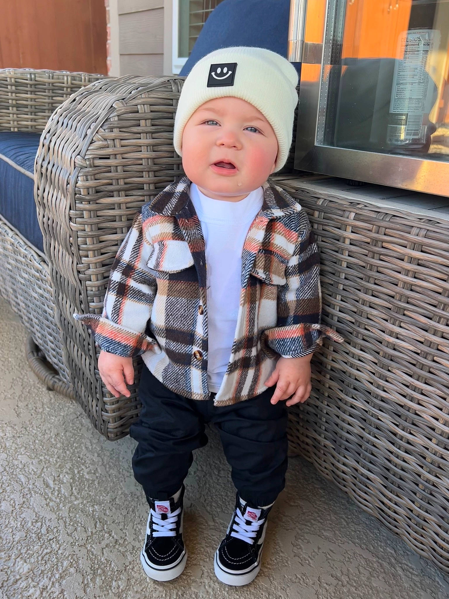 Kai joined the competition — help win amazing prizes! baby, baby_toddler_clothing, cap, child, cool, couch, fashion_accessory, flooring, headwear, leg, pattern, person, plaid, shoe, sitting, sleeve, sneakers, sock, t_shirt, tartan