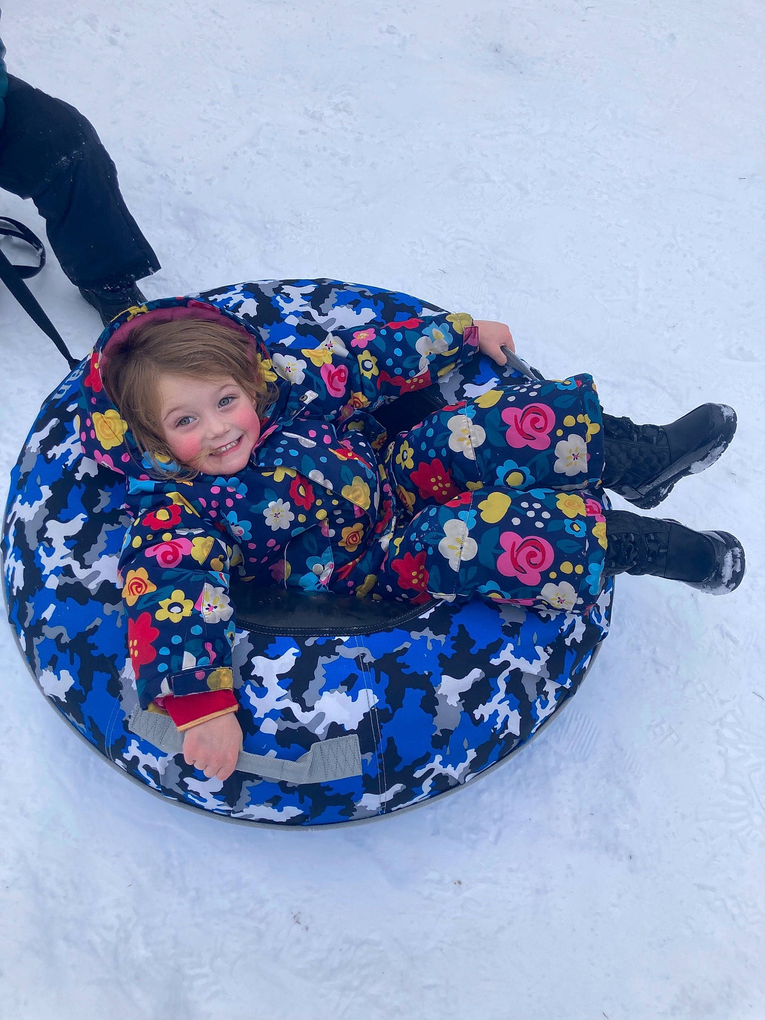 Angelina is registered to the contest to win money with this photo: baby, baby_products, baby_toddler_clothing, child, comfort, electric_blue, freezing, fun, happy, joy, leisure, pattern, person, recreation, sitting, sledding, slope, smile, snow, toddler