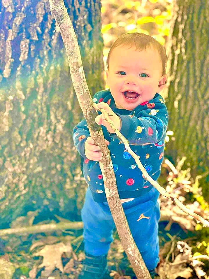 Kayden joined the competition — help win amazing prizes! baby_toddler_clothing, branch, child, face, forest, fun, grass, green, happy, head, people_in_nature, person, plant, recreation, smile, standing, terrestrial_plant, toddler, tree, twig