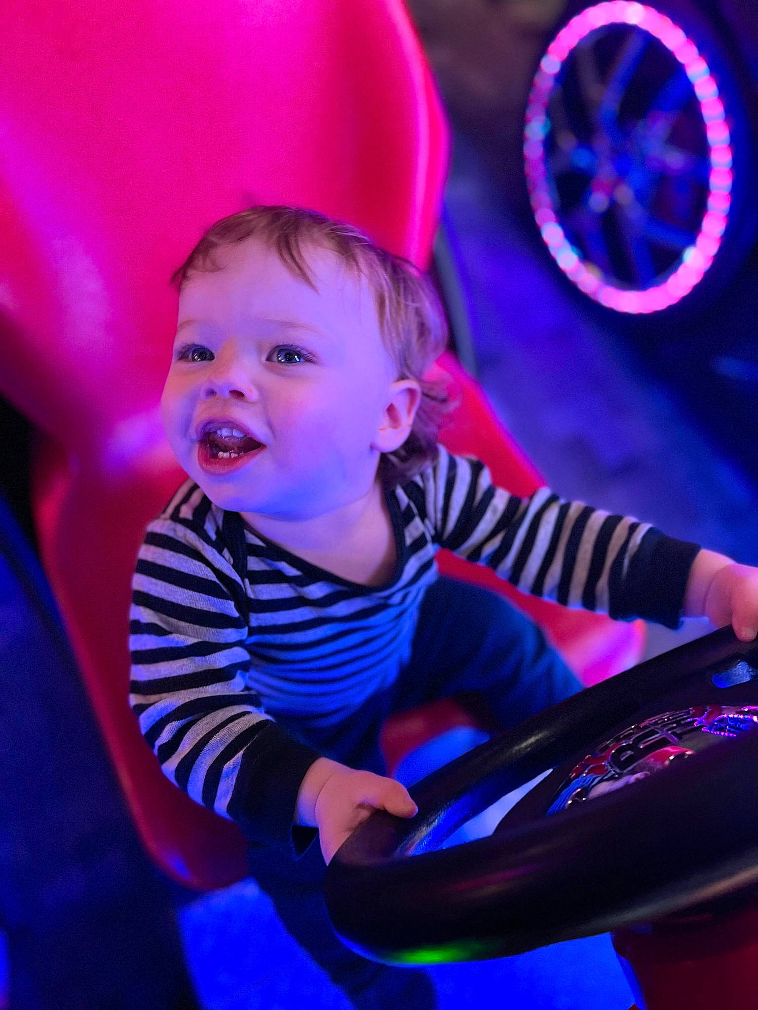 Kayden is registered to the contest to win money with this photo: automotive_tire, baby, blue, electric_blue, entertainment, flash_photography, fun, happy, light, magenta, music, organ, performing_arts, person, purple, t_shirt, tire, toddler, vertebrate, violet