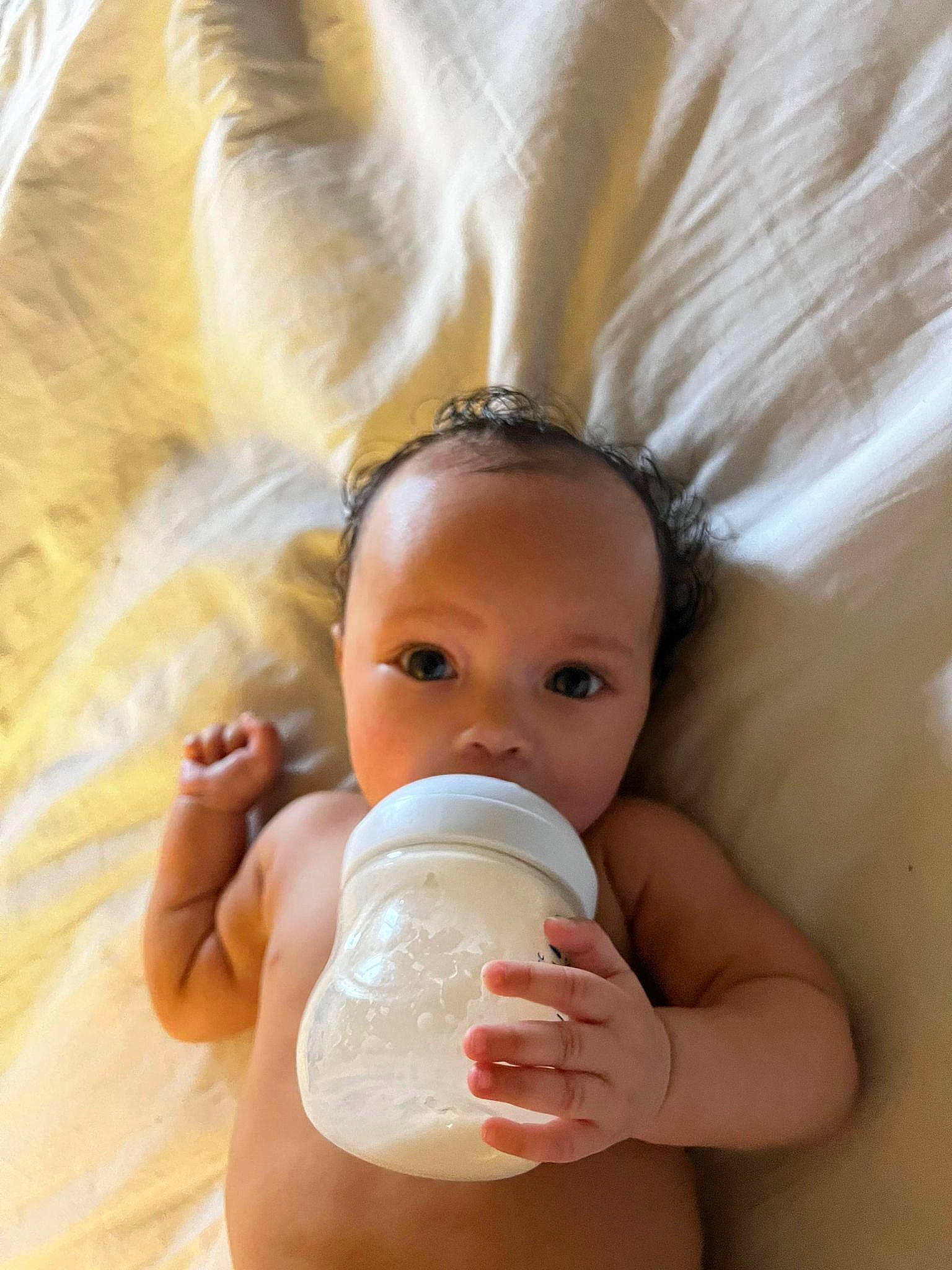 Indigo joined the competition — help win amazing prizes! baby, baby_bottle, baby_bottle_feeding, bottle, cheek, drinkware, eye, eyelash, face, finger, gesture, head, lip, liquid, milk, neck, nose, person, plastic_bottle, skin