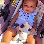 Mia joined the competition — help win amazing prizes! baby, car_seat, red_bow, stuffed_animal, sunlight, smiling, child, infant, clothing, blanket, seatbelt, happy, cute, portrait, toddler, accessory, indoor, comfort, toy, infant_girl