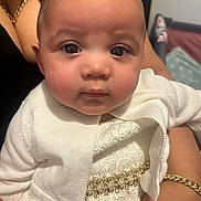 Jewelyah is registered to the contest to win money with this photo: baby, infant, child, white_clothing, lace, pearl_beads, gold_jewelry, bracelet, chain_necklace, adult_hand, closeup, portrait, face, eyes, soft_skin, indoor, holding, cute, fashion, person