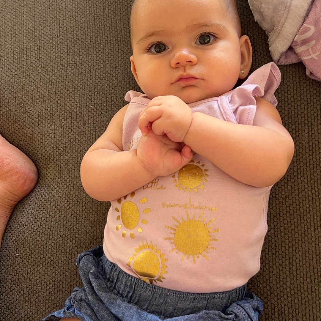 Aria joined the competition — help win amazing prizes! baby, bodypart, clothing, couch, cushion, face, finger, furniture, hand, head, homedecor, jeans, newborn, pants, person, photography, portrait, shorts, sitting, t_shirt