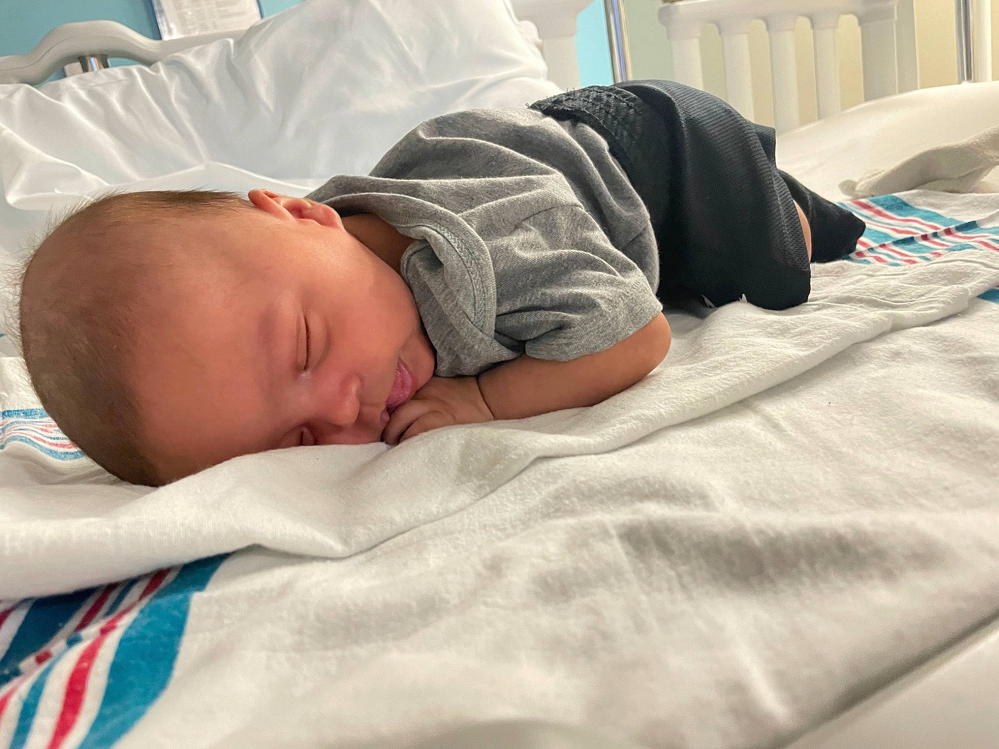 Jordan is registered to the contest to win money with this photo: baby, baby_products, baby_safety, baby_sleeping, baby_toddler_clothing, bed, bed_sheet, bedding, bedtime, child, comfort, hat, linens, nap, person, room, sleep, sleeve, t_shirt, textile