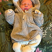 Sidney joined the competition — help win amazing prizes! baby, sleeping, hooded_jacket, fluffy_clothing, blanket, floral_pattern, infant, cozy, cute, soft_texture, child, lying_down, pajamas, warm_clothes, peaceful, adorable, newborn, portrait, indoors, resting