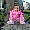 Maily is registered to the contest to win money with this photo: toddler, child, pink_jacket, socks, outdoor_chair, lawn, grass, backyard, happy, smiling, baby, cute, casual_clothing, sitting, daylight, nature, home, relaxation, playful, young_child