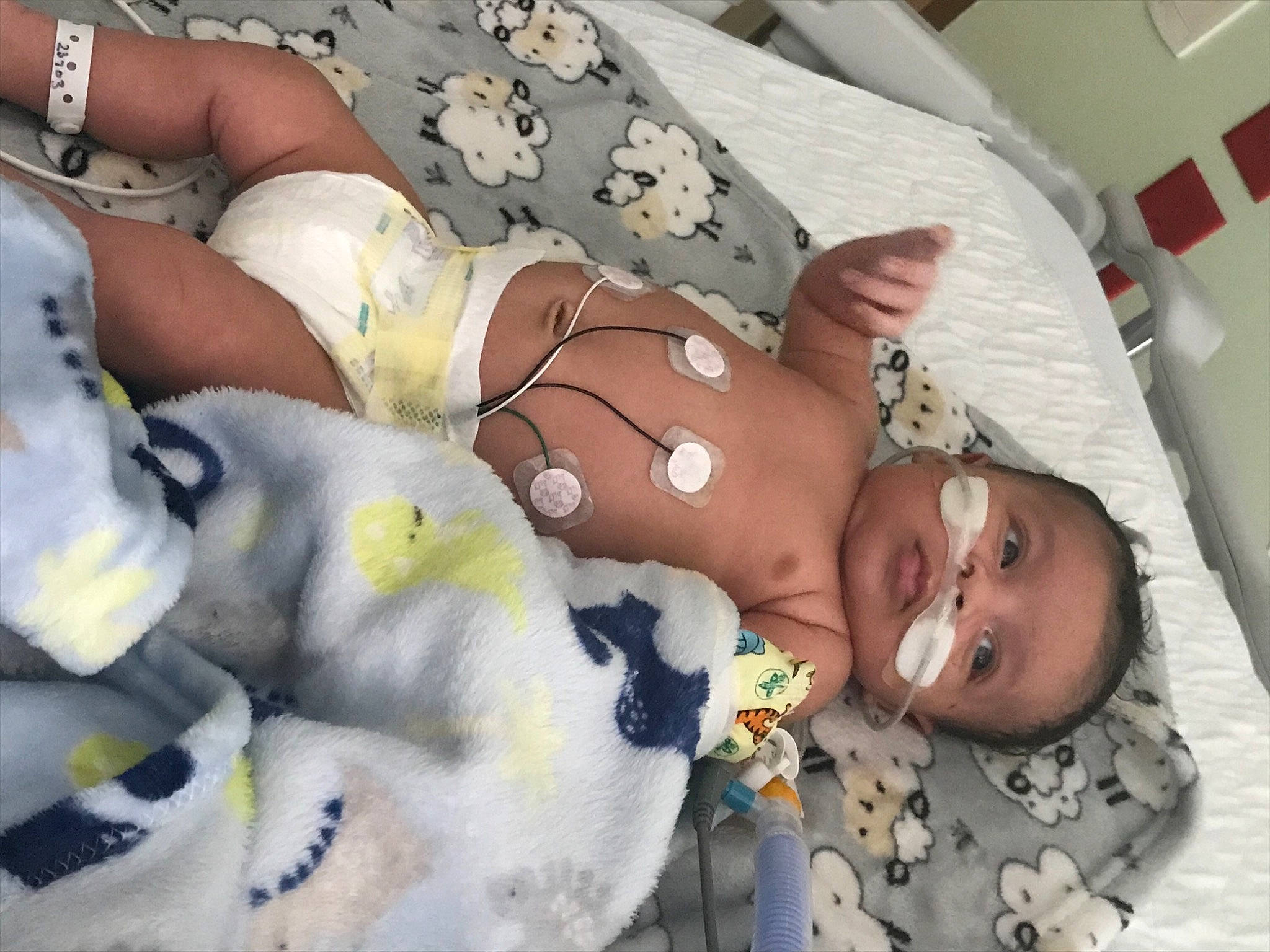 Karson is registered to the contest to win money with this photo: abdomen, baby, chest, child, comfort, human_leg, joint, linens, mouth, muscle, navel, pattern, person, room, skin, smile, textile, thigh, toddler, toy