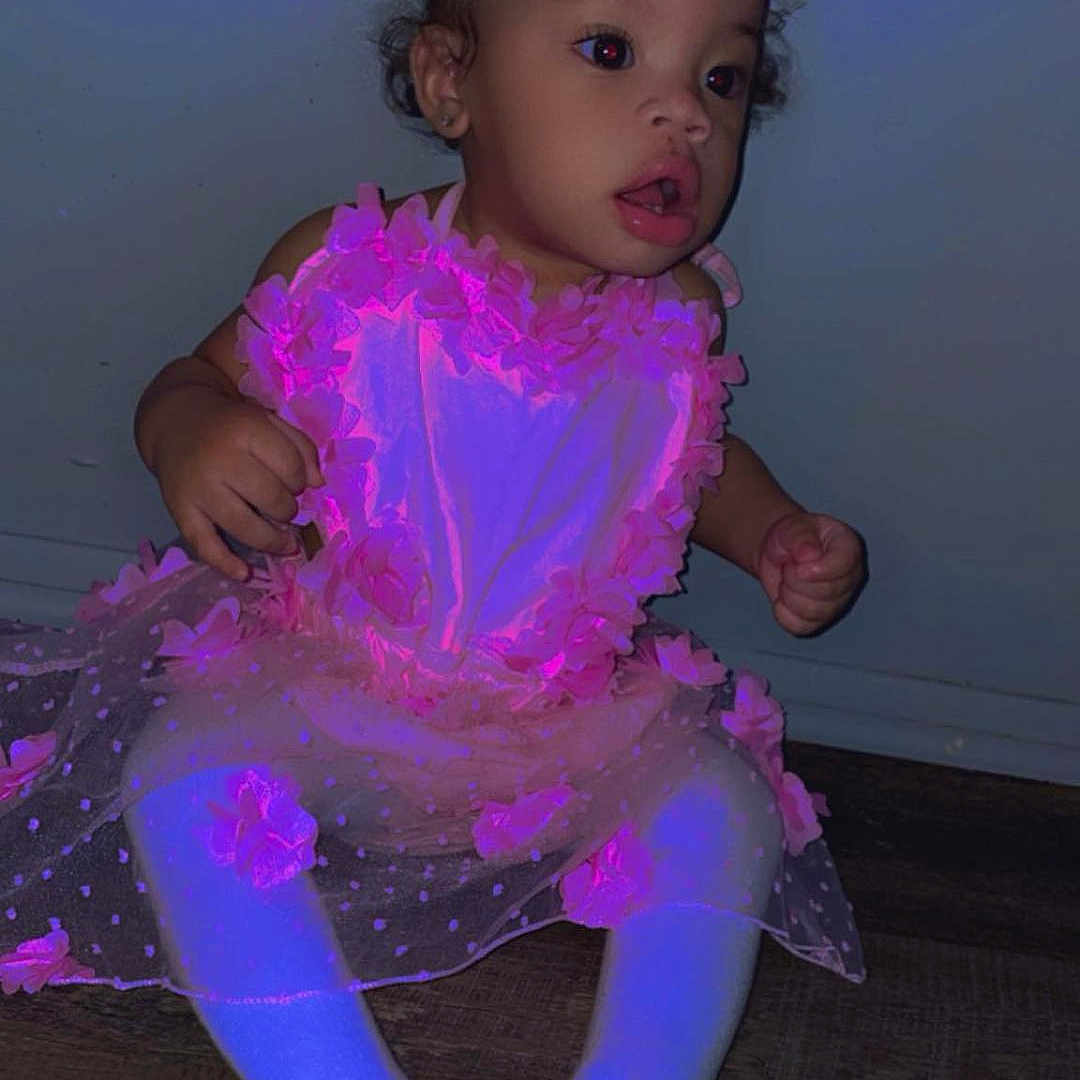 Zemariah is registered to the contest to win money with this photo: accessories, bodypart, child, clothing, costume, dress, face, female, finger, formalwear, girl, hand, head, hosiery, person, photography, portrait, purple, sitting, sock