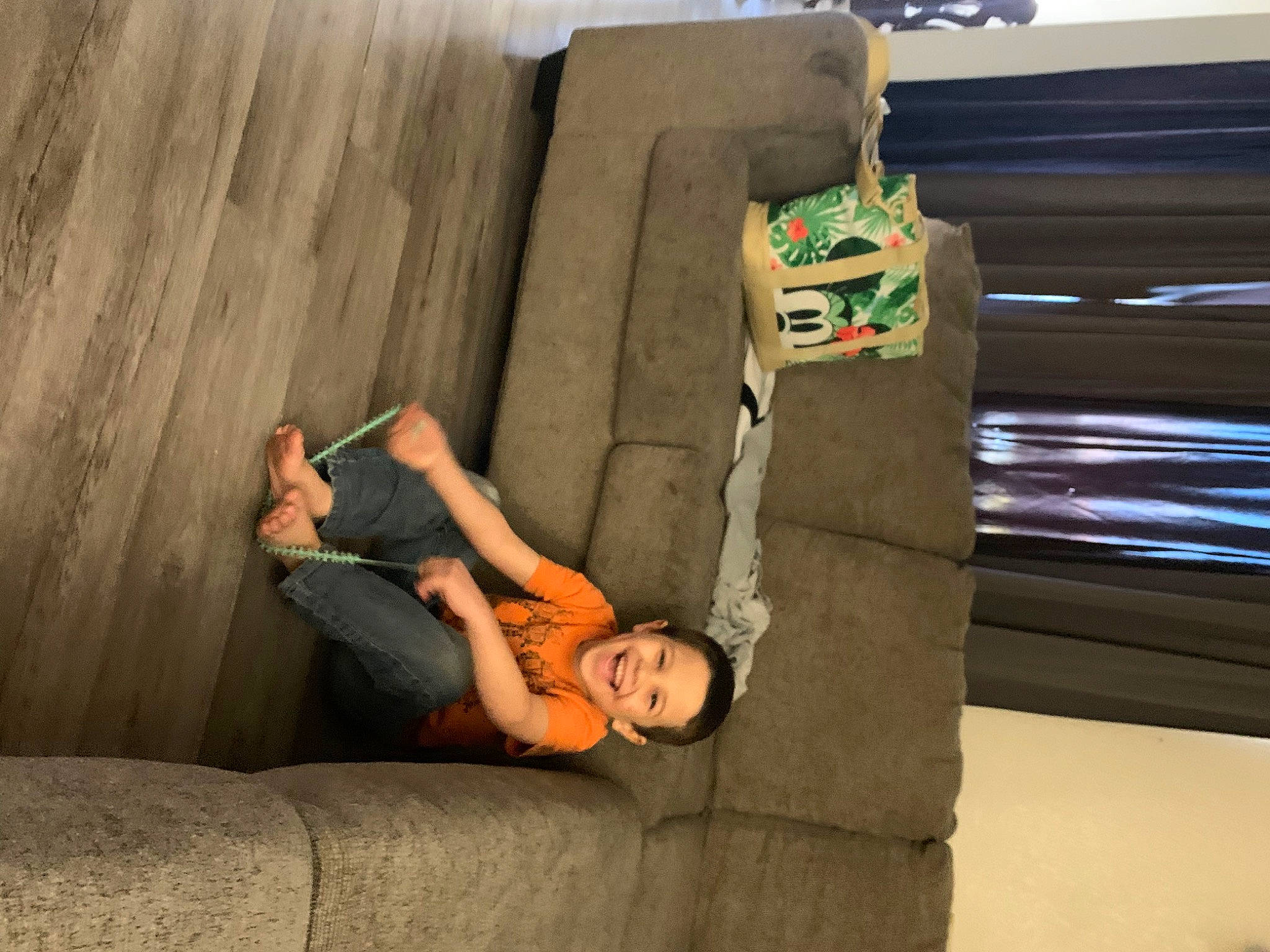 Christopher is registered to the contest to win money with this photo: arm, comfort, couch, dress, finger, flash_photography, floor, flooring, foot, fun, hardwood, human_leg, interior_design, joy, knee, leisure, person, room, sitting, thigh