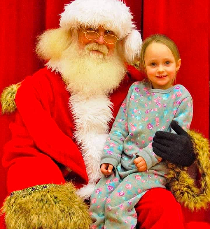 Katie is registered to the contest to win money with this photo: christmas, fictional_character, fur, holiday, joy, lap, person, santa_claus