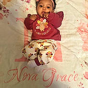 Nova joined the competition — help win amazing prizes! baby, infant, child, thanksgiving, headband, flower, blanket, floral, clothing, cute, portrait, lying_down, indoors, soft_texture, warm_colors, smiling, cozy, person, young_child, happy