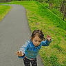 Sylvia is registered to the contest to win money with this photo: child, girl, denim_jacket, patterned_pants, pink_shoes, outdoor, pathway, grass, trees, forest, nature, walking, cute, motion, expression, hearts, emoji, spring, daytime, casual_clothing