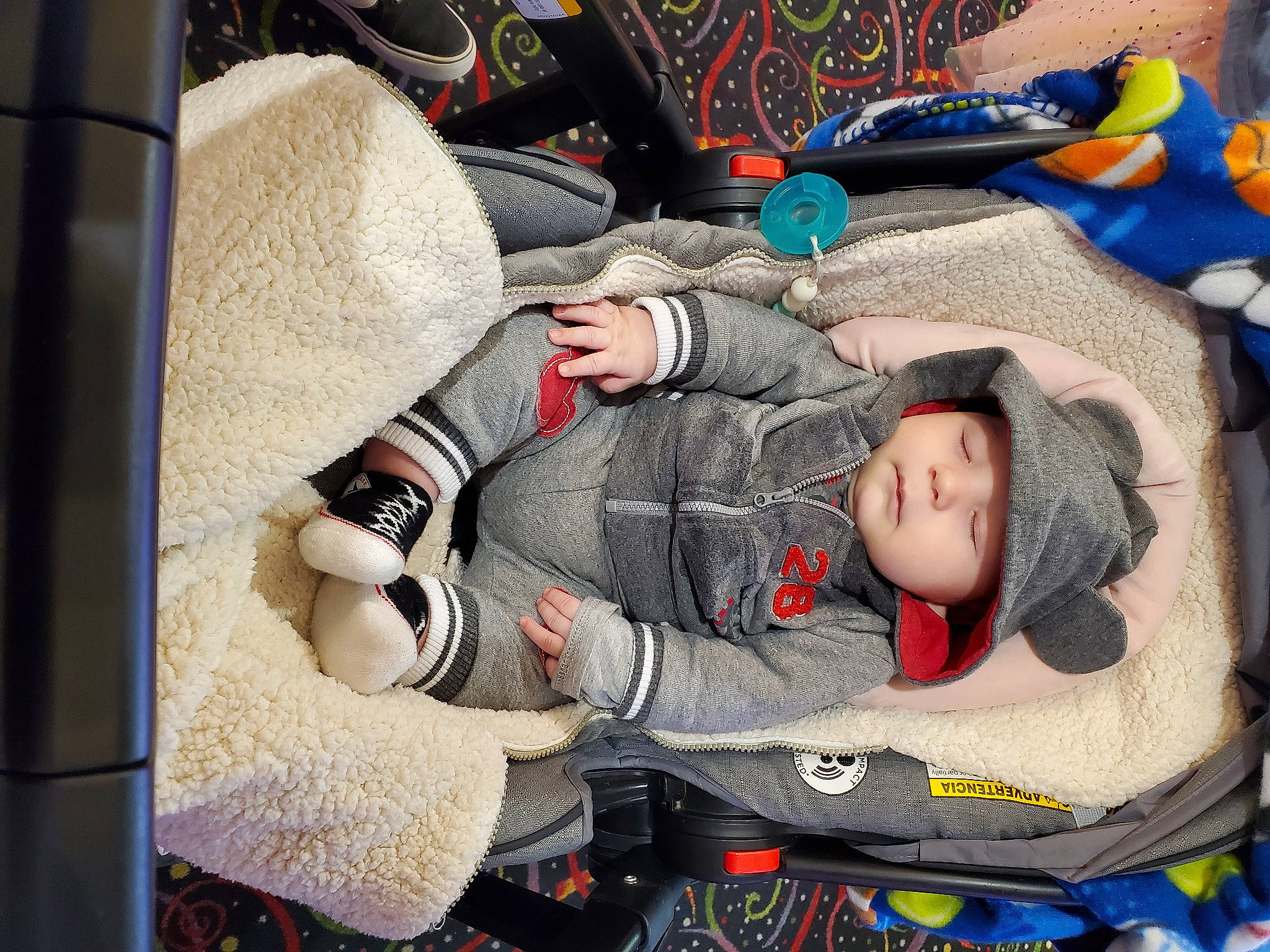 Derek is registered to the contest to win money with this photo: auto_part, baby, baby_carriage, baby_in_car_seat, baby_products, baby_sleeping, baby_toddler_clothing, bag, baggage, car_seat, car_seat_cover, carmine, child, comfort, headwear, nap, person, sitting, sleep, toddler