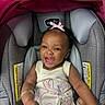 accessory, baby, bracelet, bunny_design, car_seat, child, clothing, cute, flower_design, happy, headwear, indoor, infant, knitted_outfit, person, pink_bow, portrait, seatbelt_warning, skin, smiling