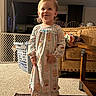 Memphys joined the competition — help win amazing prizes! toddler, child, smiling, pajamas, barefoot, rug, living_room, couch, laundry_basket, carpet, wooden_table, indoor, home, furniture, person, happy, cute, young_child, cozy, portrait
