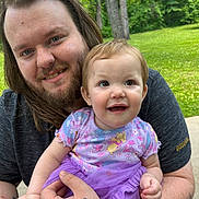 Espyn joined the competition — help win amazing prizes! adult, baby, child, smile, outdoor, nature, greenery, grass, trees, tattoo, purple_tutu, short_sleeves, holding, happy, face, person, portrait, casual_clothing, beard, long_hair