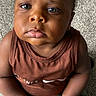 Jahmare joined the competition — help win amazing prizes! toddler, child, face, blue_eyes, brown_skin, sleeveless_shirt, carpet, hands, candid, portrait, closeup, expression, serious, person, indoor, cute, young_child, clothing, sitting, skin