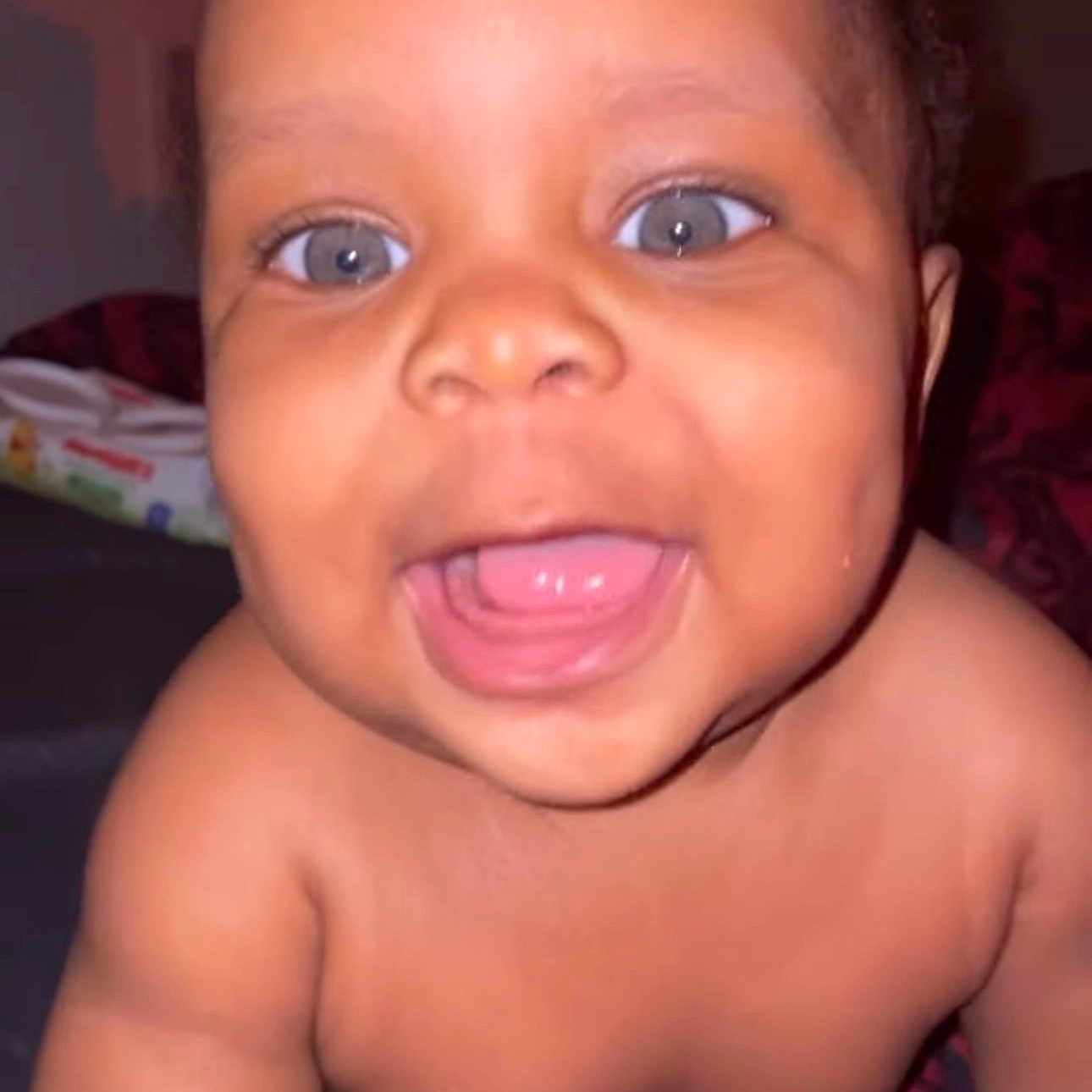 Jahmare joined the competition — help win amazing prizes! baby, child, smiling, face, eyes, mouth, tongue, skin, shoulder, infant, portrait, closeup, happy, celebration, text_overlay, red_hearts, blanket, indoors, cute, person