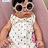Everlee is registered to the contest to win money with this photo: baby, child, sunglasses, onesie, ladybug, pink, bouncer, headband, black_bow, infant, cute, fashion, accessory, portrait, outdoor, seat, clothing, face, hands, relaxing