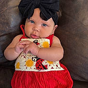 Everlee is registered to the contest to win money with this photo: baby, infant, child, headband, black_bow, red_outfit, sunflower, ladybug, couch, leather, hands, cute, portrait, indoor, skin, face, smile, blue_eyes, clothing, seated