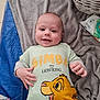 Thyméo participe au concours pour gagner de l'argent avec cette photo : baby, basket, blanket, blue, child, clothing, cute, fabric, face, gray, hand, happy, indoors, infant, lion_king, lying_down, shirt, simba, smile, soft_texture