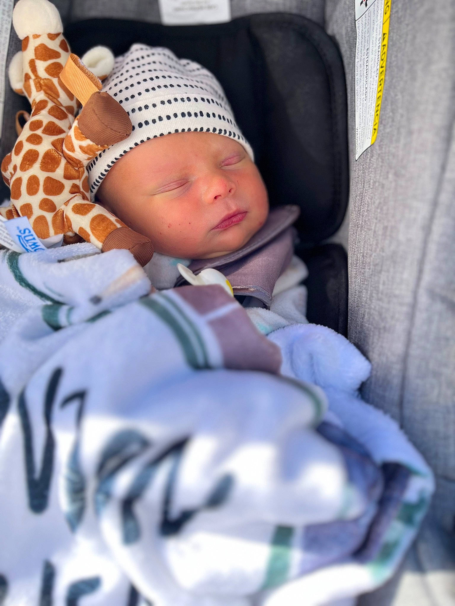 Brandon is registered to the contest to win money with this photo: baby, baby_products, baby_sleeping, baby_toddler_clothing, beanie, cap, child, comfort, headwear, human_leg, knit_cap, linens, nap, pattern, person, portrait_photography, sitting, sleep, sleeve, textile
